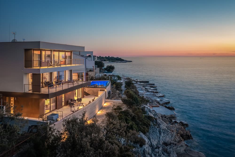 Rogoznica 6 contemporary villa exterior with illuminated terraces at dusk, Rogoznica, Croatia